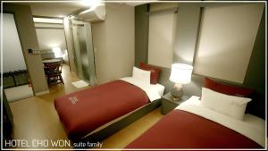 Postel nebo postele na pokoji v ubytování Hotel Chowon
