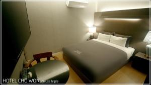 Postel nebo postele na pokoji v ubytování Hotel Chowon