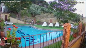 a swimming pool with a fence around it at Alojamiento Nohal in La Iruela