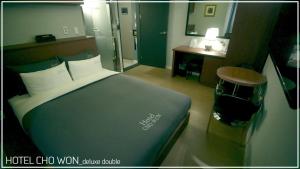 Postel nebo postele na pokoji v ubytování Hotel Chowon