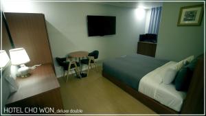 Postel nebo postele na pokoji v ubytování Hotel Chowon