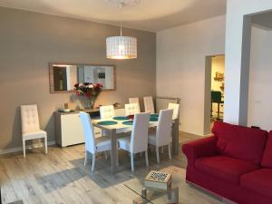 a living room with a table and a red couch at CittadellaChiara in Sestri Levante
