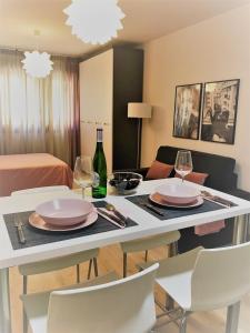 a living room with a table with plates and wine glasses at Estudio Alicante Centro in Alicante