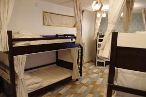 Postel nebo postele na pokoji v ubytování Cinnamon Guesthouse Dogo