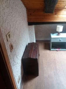 a wooden bench in a room with a table at Mansarda 2 in Commezzadura