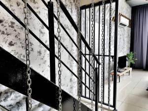a black staircase with a chain railing in a room at Escapade Prison Suites Petaling Jaya in Petaling Jaya +50 photos