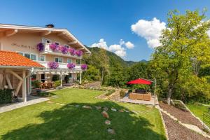 an exterior view of a house with a yard at Haus Bella Vista in Reit im Winkl