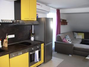 a kitchen with a stove top oven next to a couch at Ubytovani Bára Jižní Morava Břeclav Hodonín in Prušánky