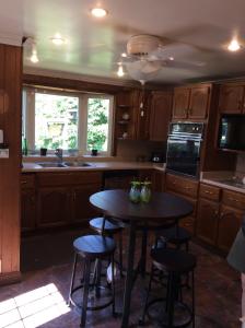 a kitchen with a table and some chairs in it at A Day at the Lake Cottage in Colchester