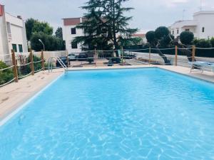 a large blue swimming pool in front of a building at La Dimora in Bari