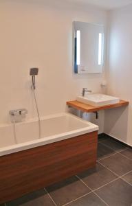 a bathroom with a bath tub and a sink at Spacious house at the gate of Giant Mountains in Víchová nad Jizerou