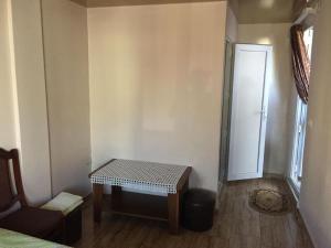 a small room with a table and a door at luiza in Batumi +1 photo