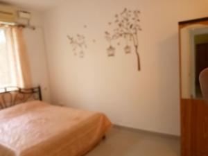 a bedroom with a bed and a wall with drawings on the wall at Casberly Apartment in Varca +16 photos