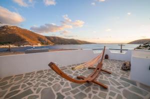 a hammock on a balcony with a view of the ocean at Greek Island Charming Studio in Amorgos +5 photos