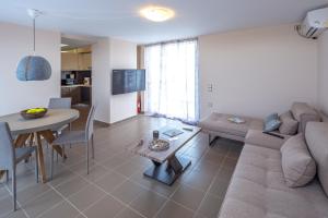 a living room with a couch and a table at Solon - Deluxe City Center Apartment in Athens
