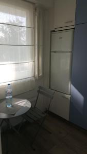 a kitchen with a table and a bottle of water next to a window at Savonlinna Holidays apartments in Savonlinna