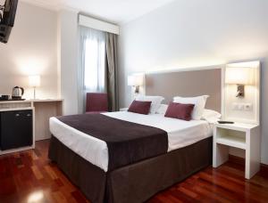 Posteľ alebo postele v izbe v ubytovaní Hotel Maestranza