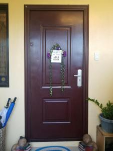 a brown door with a sign on it at Skylab Guesthouse in Manila