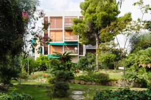 a building in the middle of a garden at Luxury Apartment with bay view in Sanremo