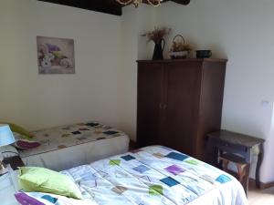 A bed or beds in a room at Hospedaje - Ferrería Quintá