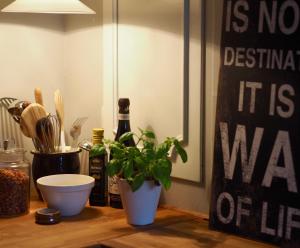 a table with a plant and a bottle of wine at Elins Lycka i Viken in Viken