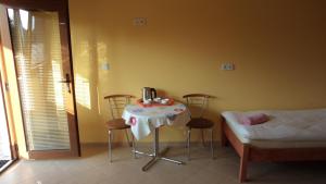 a room with a table and chairs and a bed at Bacówka Noclegi in Sierpnica