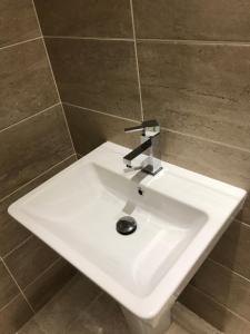 a white sink with a faucet in a bathroom at Two Little Ducks Guesthouse in Ellesmere Port
