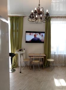 フォンタンカにあるApartments in Avtorskiyのリビングルーム(テーブル、壁掛けテレビ付)