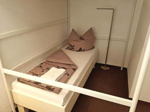 a small room with a bed with a pillow on it at Casa Conne in Rudolstadt