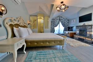 a bedroom with a large bed and a fireplace at Kartepe Köşkü in Kartepe