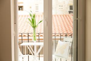 a vase with a plant on a table on a balcony at Julio Antonio Apartment Center in Valencia