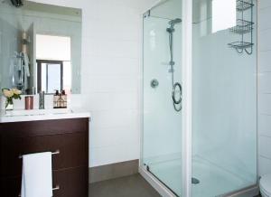 a bathroom with a shower and a sink at Apartment 33 - Post Office Lane in Wanaka +18 photos