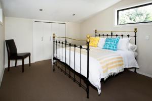a bedroom with a bed and a chair at Apartment 33 - Post Office Lane in Wanaka