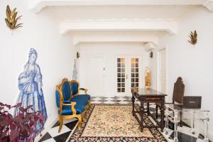 a living room with a table and chairs at Sra da Oliveira Solar Heritage in Leiria