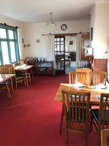 a dining room with wooden tables and chairs at Picton House B&B and Motel in Picton
