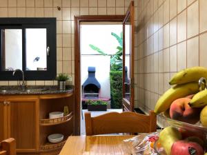 a kitchen with a table with a bunch of bananas at Casa Coromines in Alcudia