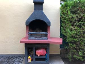 a outdoor pizza oven sitting next to a wall at Casa Coromines in Alcudia