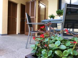 a patio with a table and chairs and flowers at Casa Coromines in Alcudia