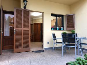 a door leading to a patio with a table and chairs at Casa Coromines in Alcudia
