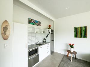 a kitchen with white cabinets and a sink at The Rise in Waimate North