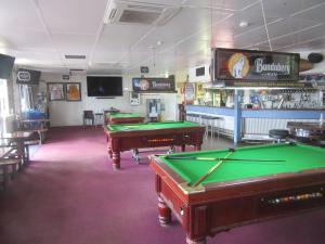 a bar with two pool tables in a room at Dampier Mermaid Hotel Karratha in Dampier
