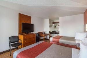 a hotel room with two beds and a flat screen tv at Motel 6-Van Buren, AR I- 40 in Van Buren