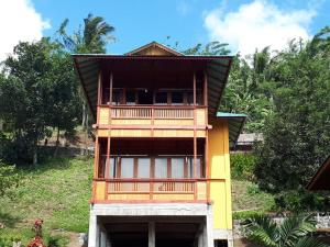 a building with a balcony on top of it at Botanica Nature Resort in Bitung +40 photos