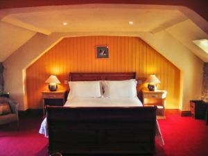 a bedroom with a large bed in a room with an attic at Clenaghans in Moira