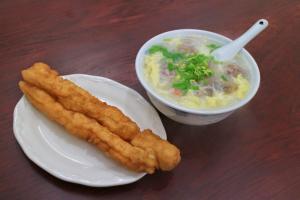 a plate of food with a bowl of soup at Fuzhongju Homestay in Jincheng