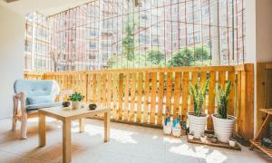 a room with a chair and a table and a window at Wuhan Wuchang·Chuhe Han Street· Locals Apartment 00004640 in Wuhan