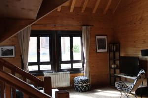 una sala de estar con una gran ventana en una cabaña en Piedrafita Mountain, en Piedrafita de Jaca