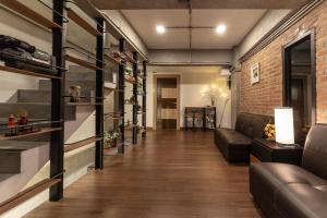 a living room with a couch and a brick wall at Feel Nimman Boutique in Chiang Mai