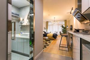 a kitchen and living room with a sink and a bedroom at Wuhan Wuchang·Star City· Locals Apartment 00121940 in Wuhan
