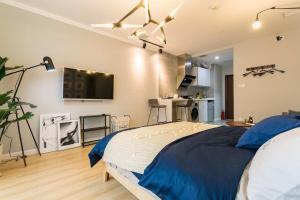 a bedroom with a bed and a tv on the wall at Wuhan Wuchang·Star City· Locals Apartment 00121940 in Wuhan